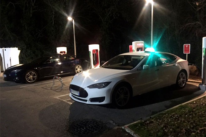Taxi électrique Tesla en charge sur un superchargeur